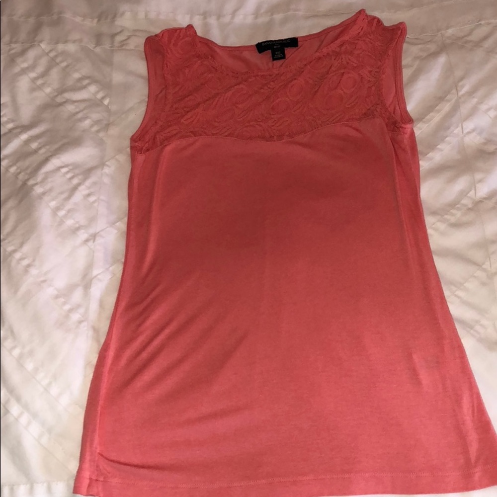 Sleeveless coral top with lace detailed neckline